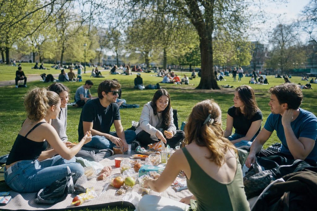 Students having a picnic in a London park
