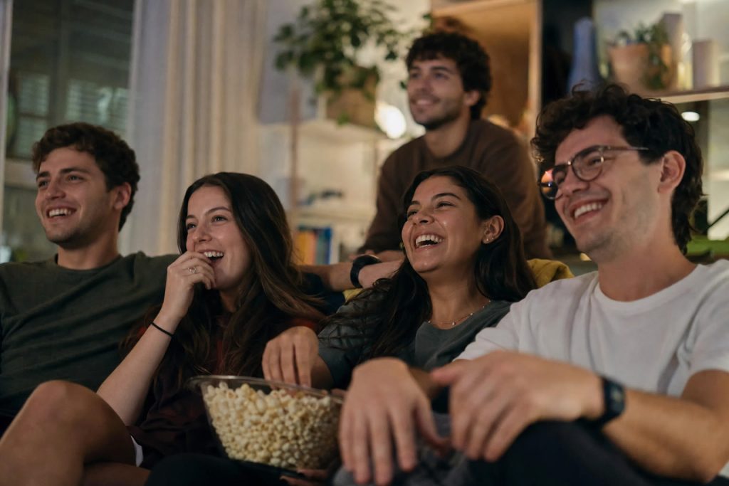 Students laughing while watching a British comedy