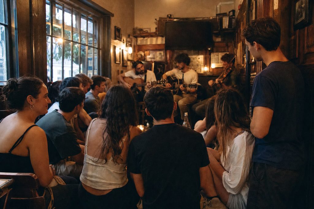 Students listening to live music in a London pub