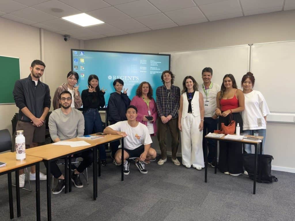 Group of students and staff standing in a classroom at Regent's School of English
