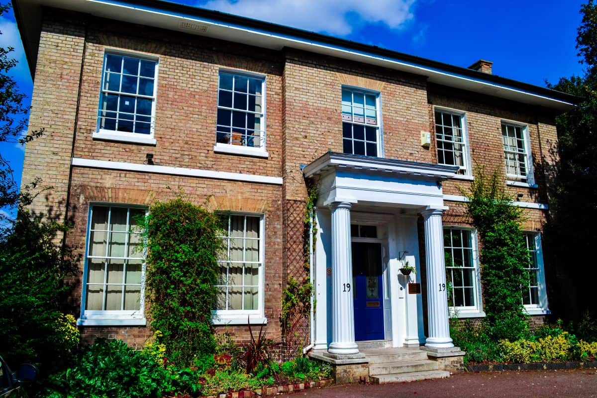 Brick Georgian-style building with a columned porch at ILC Colchester
