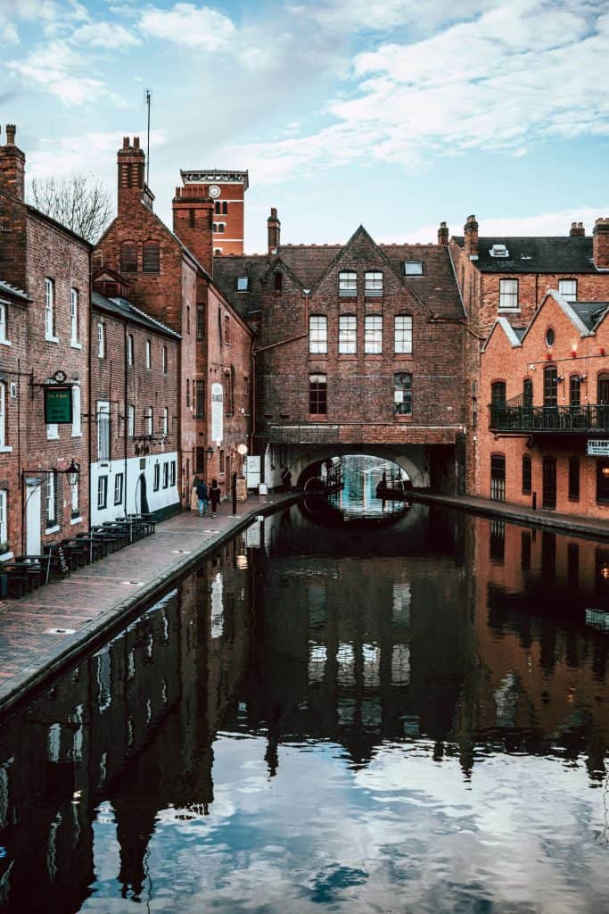 Brown brick building beside river during daytime