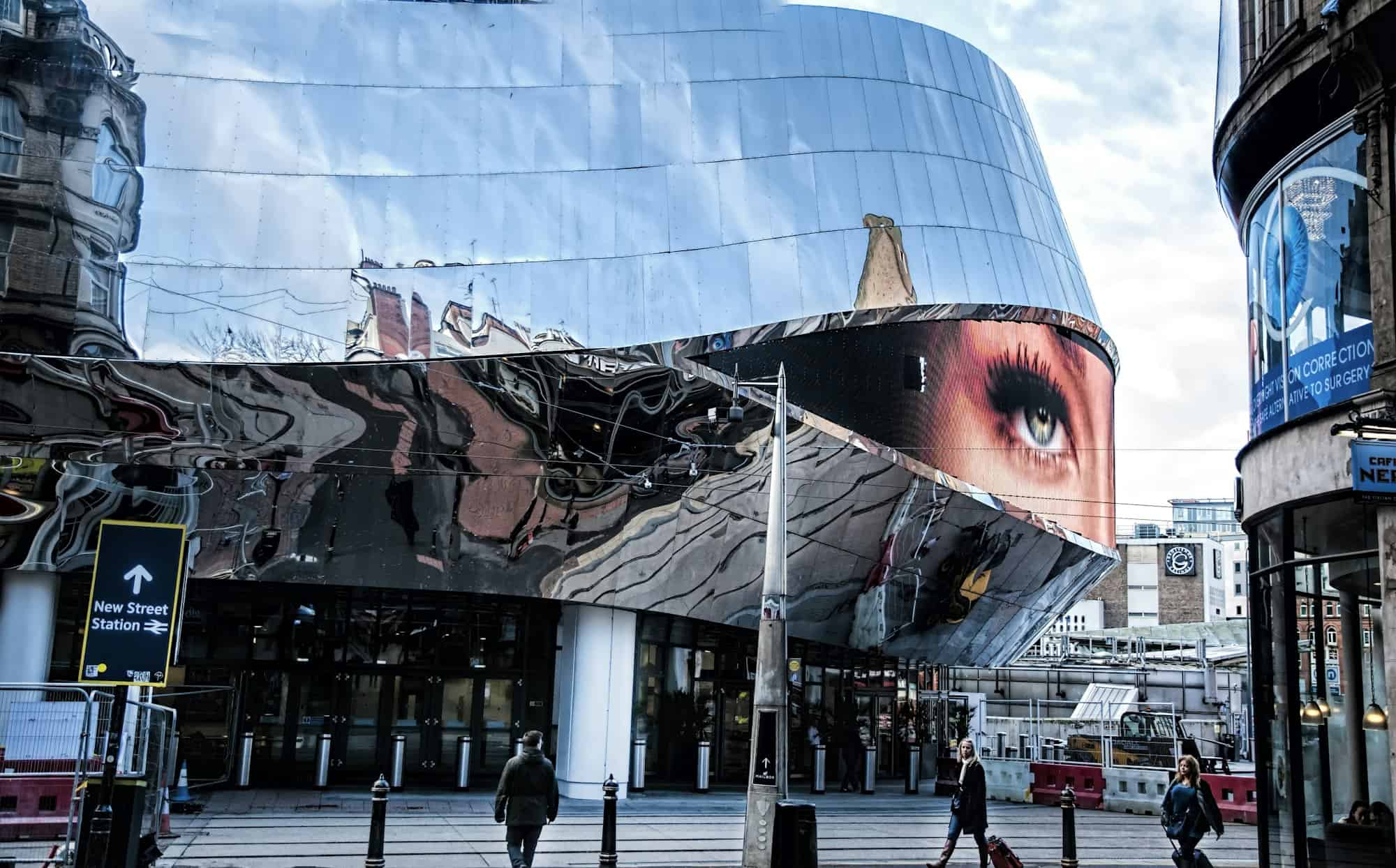People walking near glass building during daytime