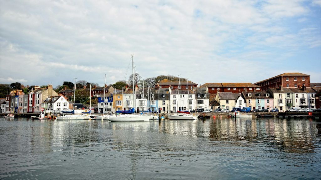 Weymouth harbour with colourful boats and waterfront buildings