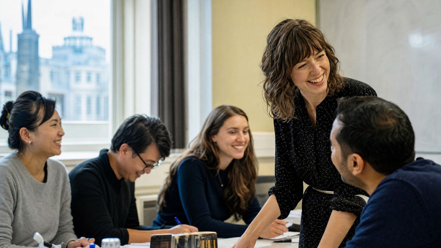 A teacher and students laughing during a General English class
