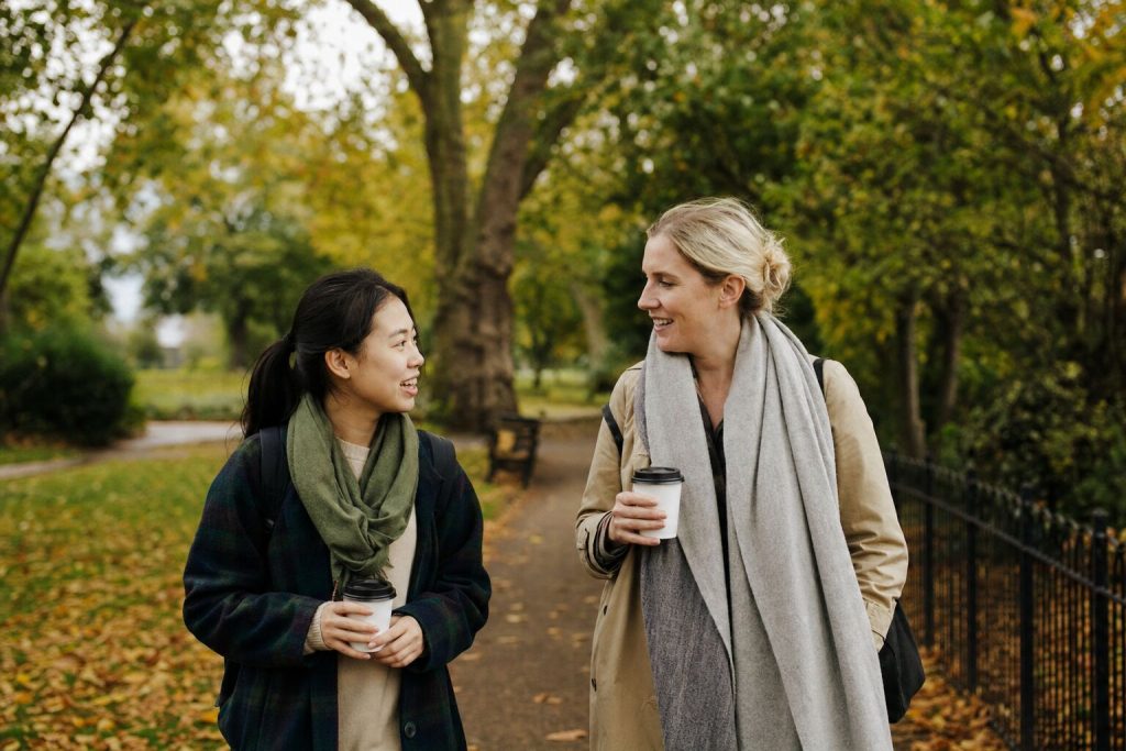 A student and her host tutor walking in a London park